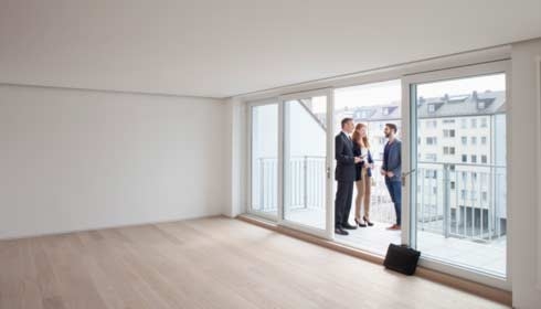 Young couple viewing flat with estate agent