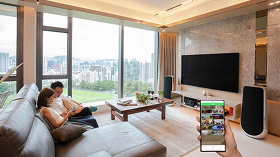 A man and a woman watching tv inside a luxury apartment
