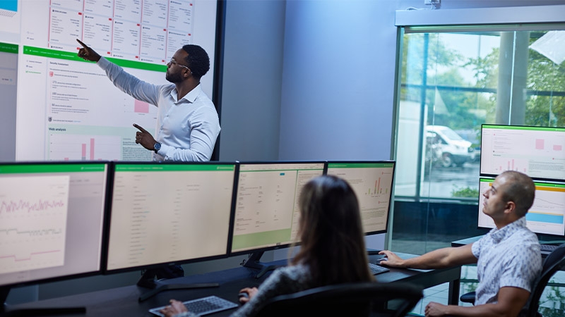 services experts from network operating center analyzing predictive analytics dashboards