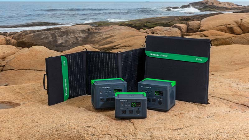 A group of electronic devices on a rocky beach