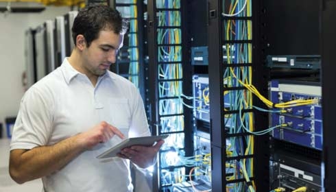 Man on tablet using data centre operations software