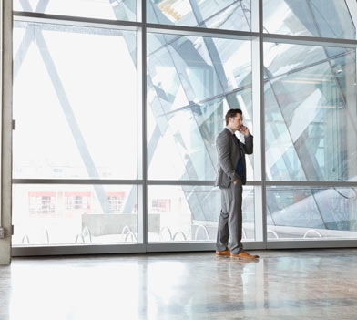 Businessman using mobile phone in office building