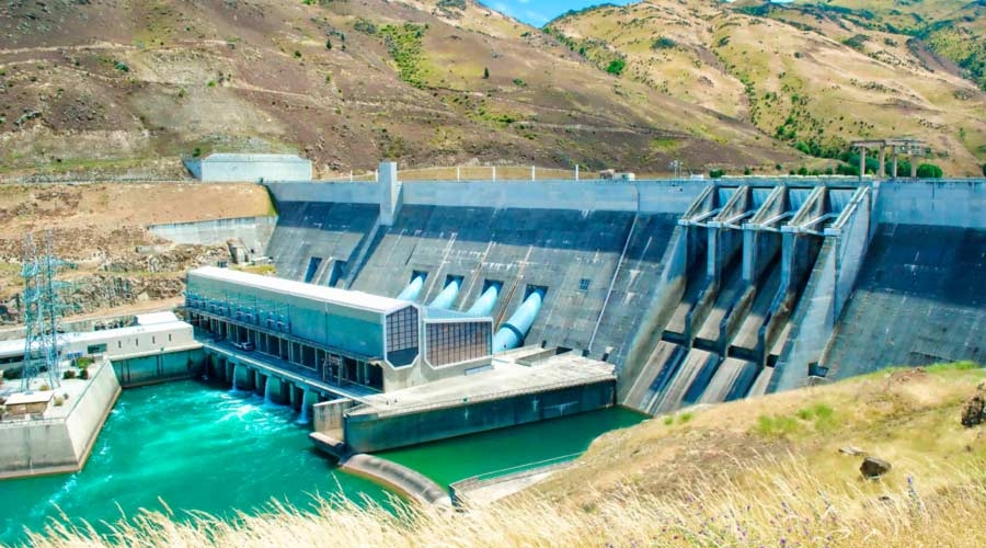Hydro electric dam with grassland and hills, water management, energy efficiency.