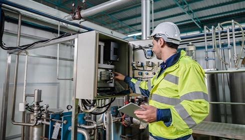 A person in a safety jacket and helmet