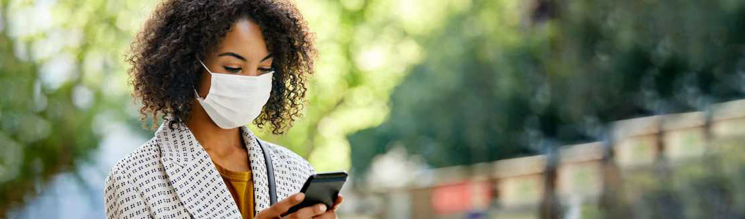 Woman with face mask and smartphone