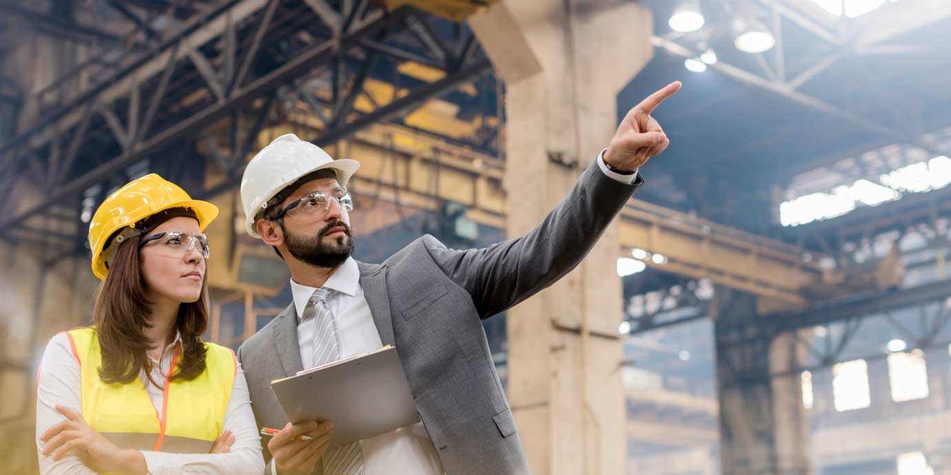 Man and woman discussing at a factory