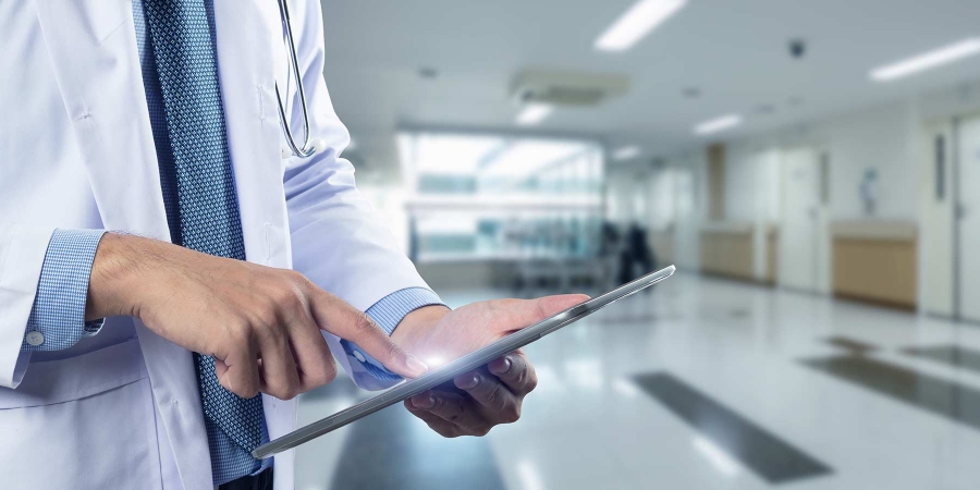 Doctor using a digital tablet computer at work