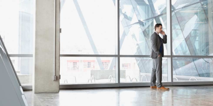 Businessman using mobile phone in office building