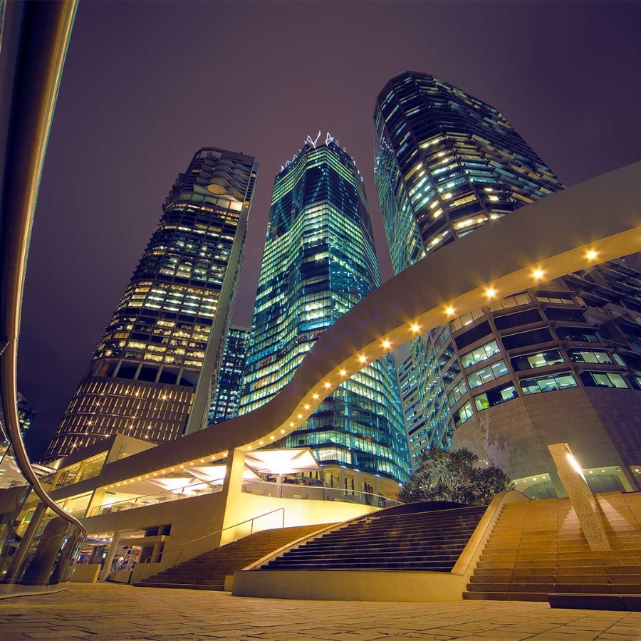 Nightscape of tall buildings connected to the smart electricity distribution network.