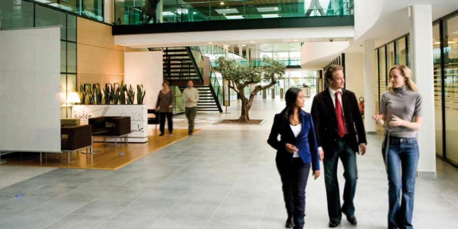 People walking through a building's lobby, sustainability consulting