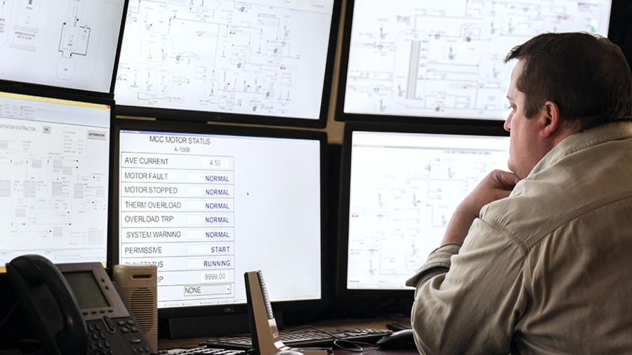 Employee looking at the data on screens