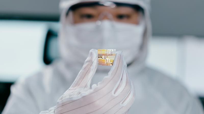 Semiconductor manufacturing engineer holds the semiconductor chip