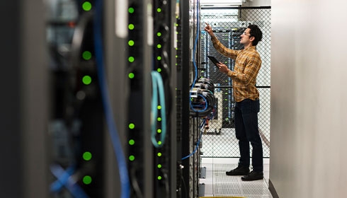 A person standing in a server room