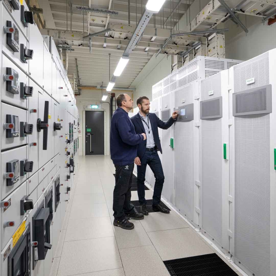 two male engineers are in Data center server room