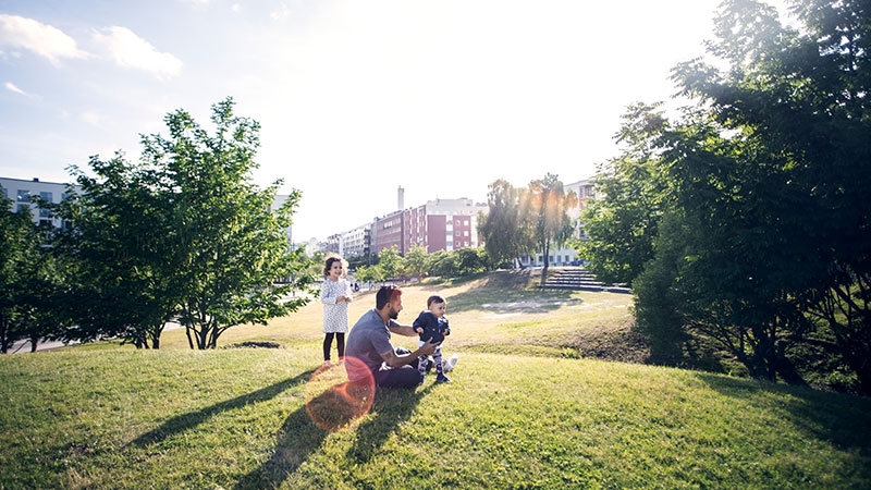 man with kids in park