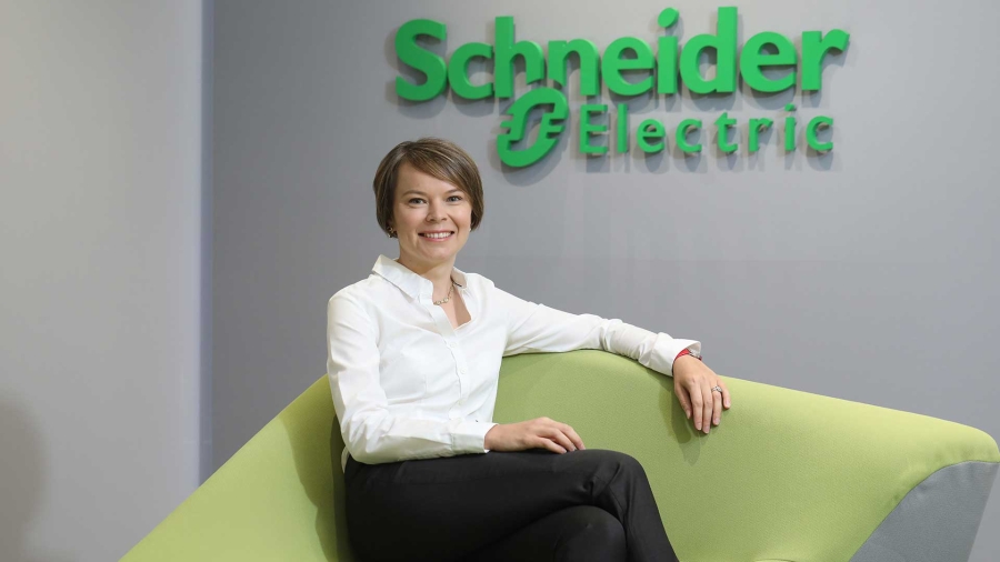 A woman sitting in Schneider office
