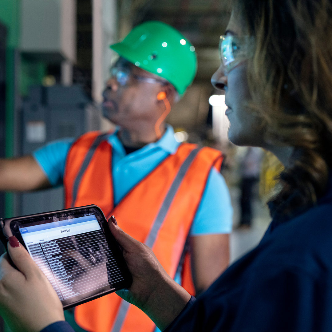 woman using tablet with worker in background