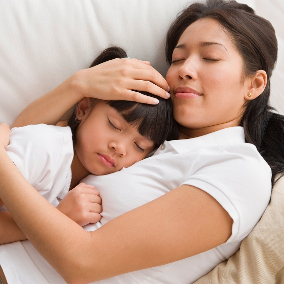 a mother and daughter sleeping peacefully