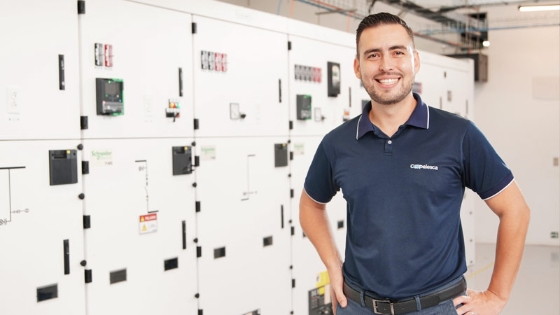 Man looking straight ahead, with Low voltage switchboards Okken behind him.
