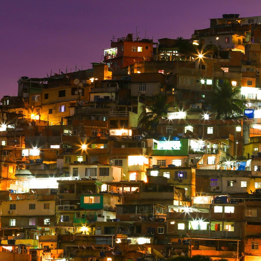 Illuminated Residential Buildings Against Sky At Night