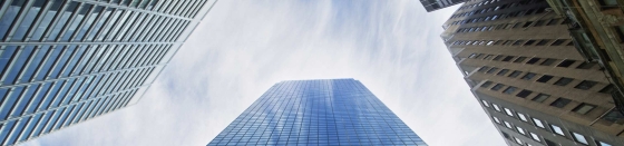 View of tall skyscrapers from below looking up, smart city.