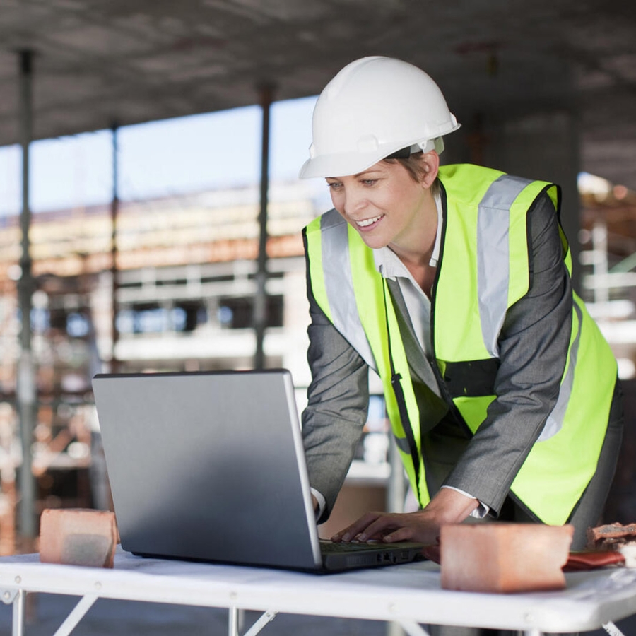 women engineer at site with laptop