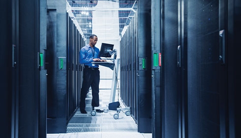 A person standing in a server room