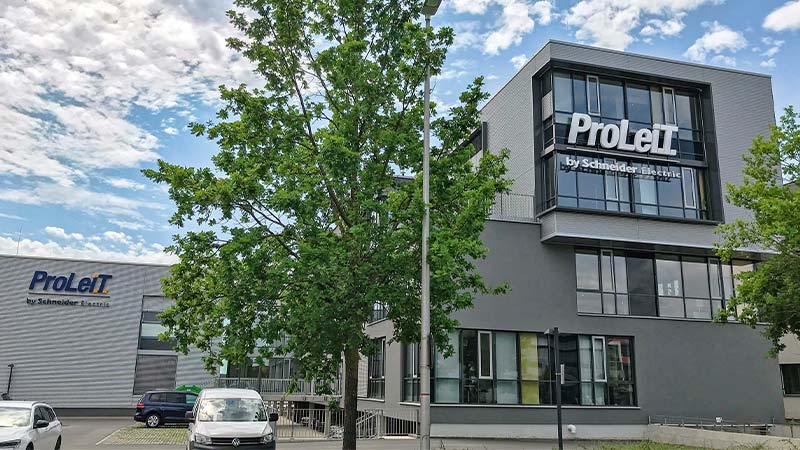 Proleit building with a tree in front of it