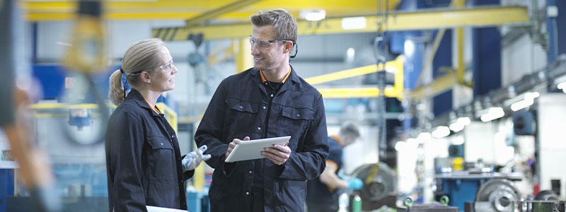 A person holding a clipboard and looking at another person