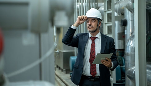 A person in a suit and tie holding a tablet