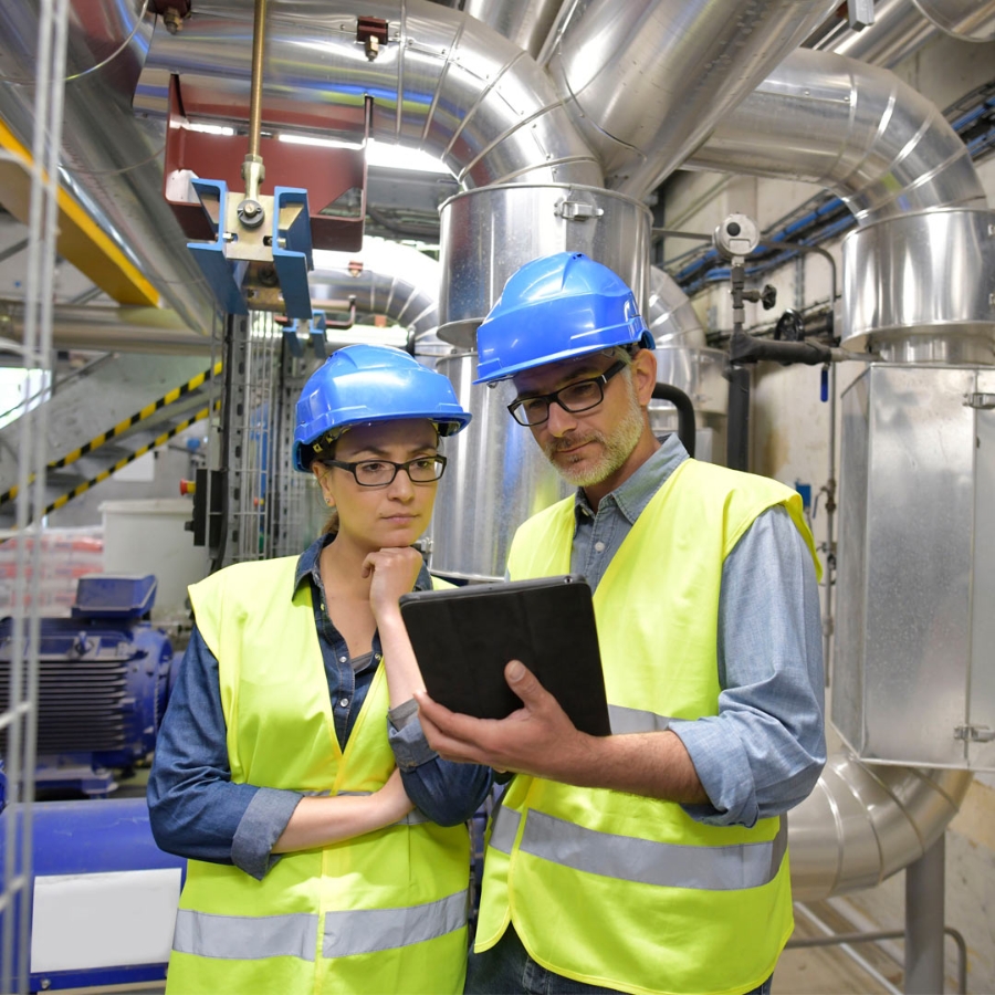 engineers working in plant with tablet