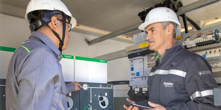 two technicians monitoring health of medium voltage equipment