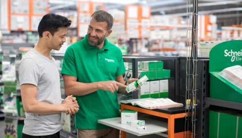 Schneider retail employee shows products to customer