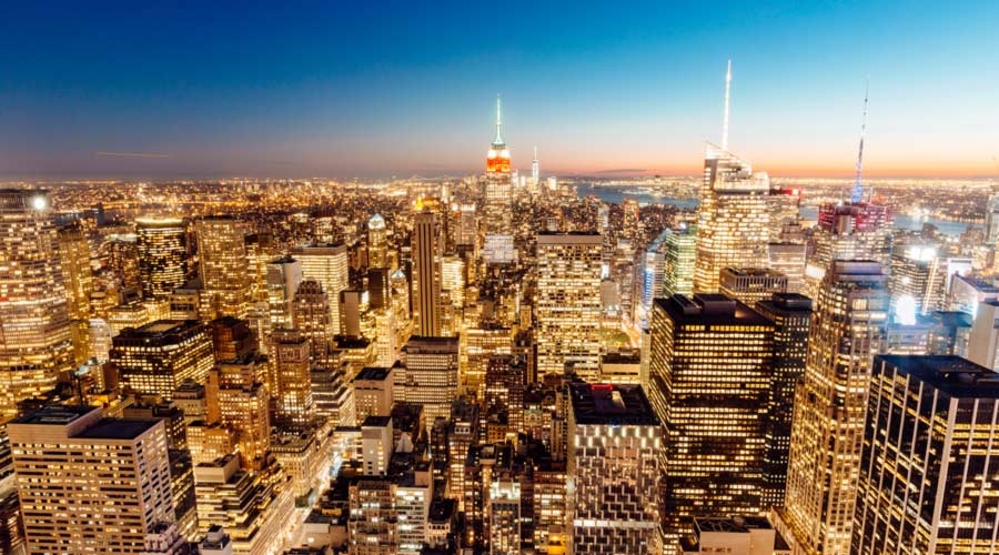 Illuminated skyscrapers of Manhattan at sunset, New York City, USA