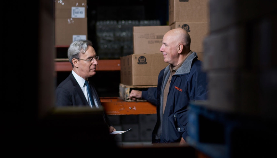 Two men in a storage room