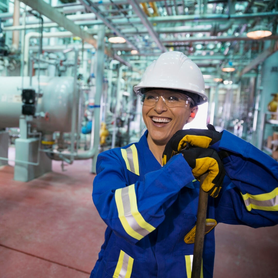 cheerful female worker in gas plant