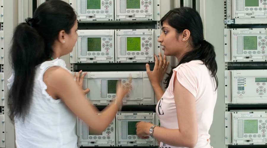 Technicians at control panels, energy management, power management.