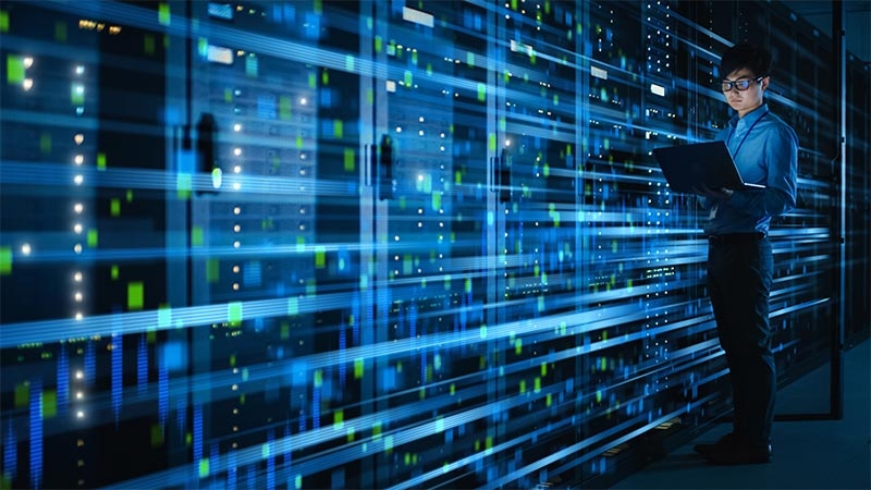 A person standing in front of a computer server