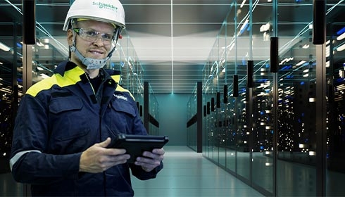 A person in a hard hat holding a tablet