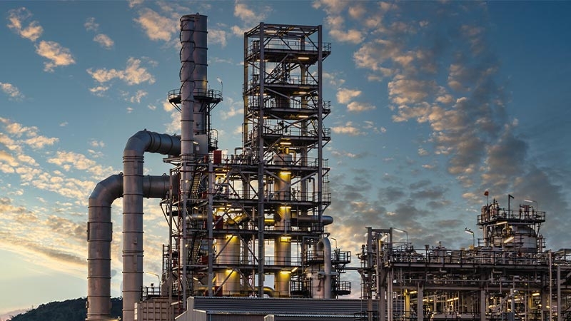 A factory with a cloudy sky