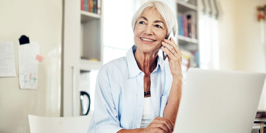 An old age lady talking to someone on a phone call