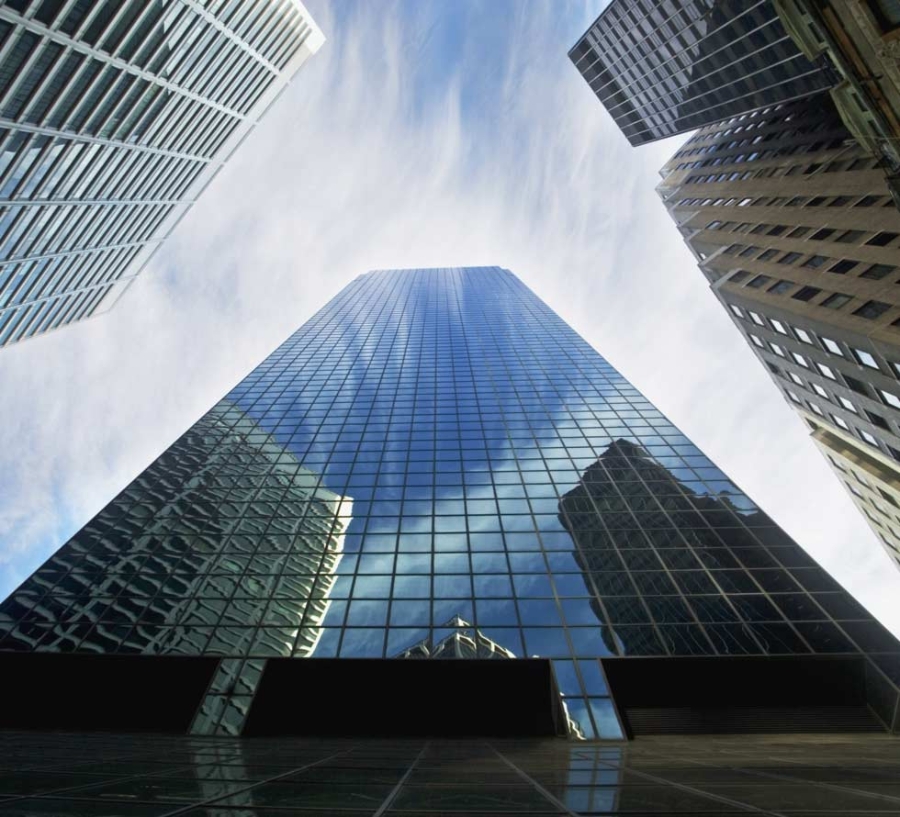 View of tall skyscrapers from below looking up, smart city.