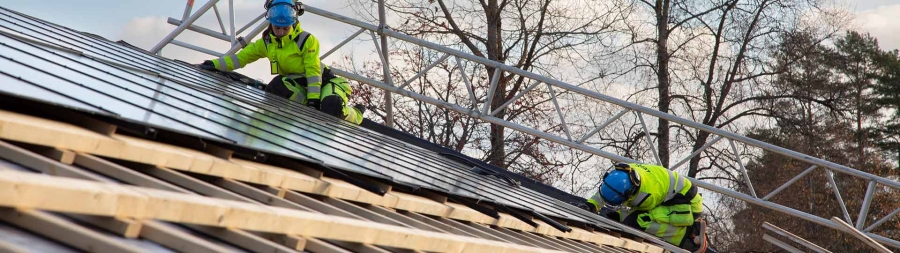 Builders laying solar panels on the roof on Villazero