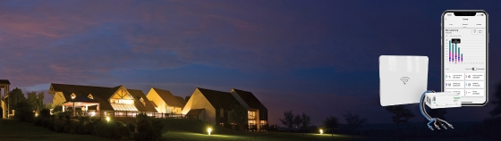 Fully lit house at night showing Energikoll with Wiser gateway, Powertag and Wiser app