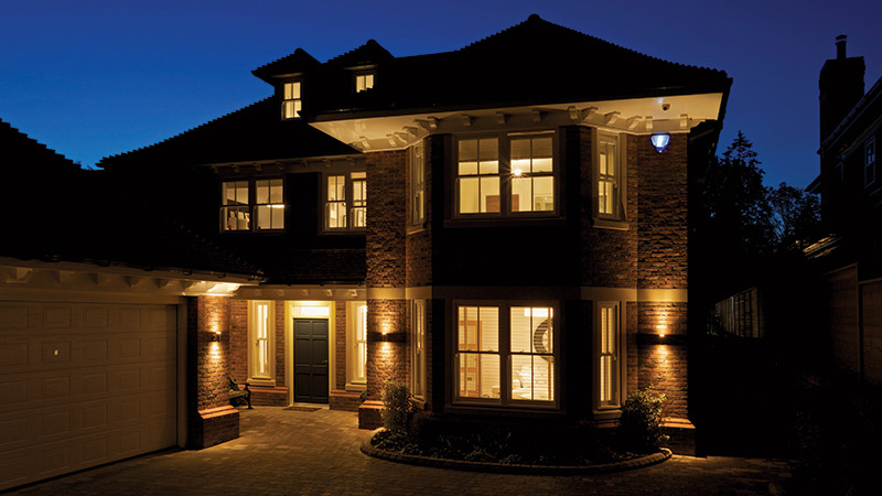 Fully lit house at night with dark blue sky in background