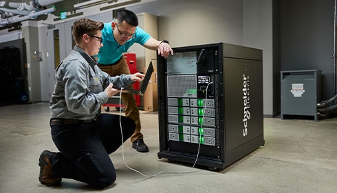 A person and person looking at a computer