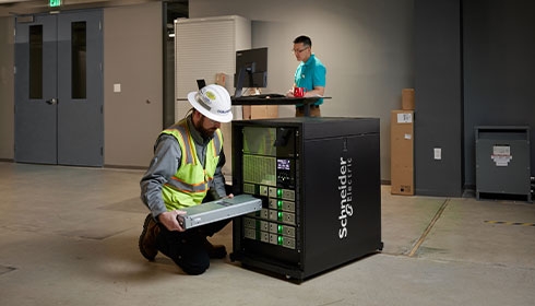 A person in a hard hat working on a machine