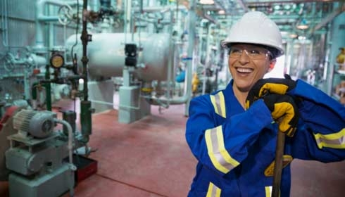 Female worker smiling in gas plant