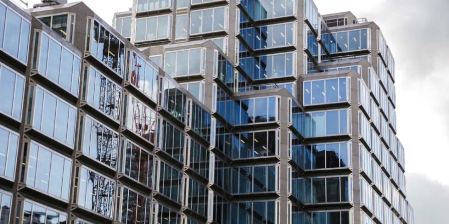 Commercial building with lots of windows for energy efficiency, smart buildings in smart cities.