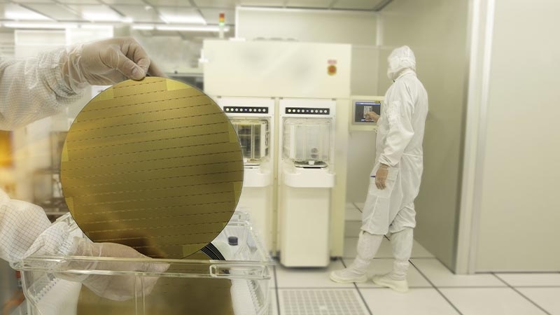 Hands holding a silicon wafers at clean room laboratory semiconductor production